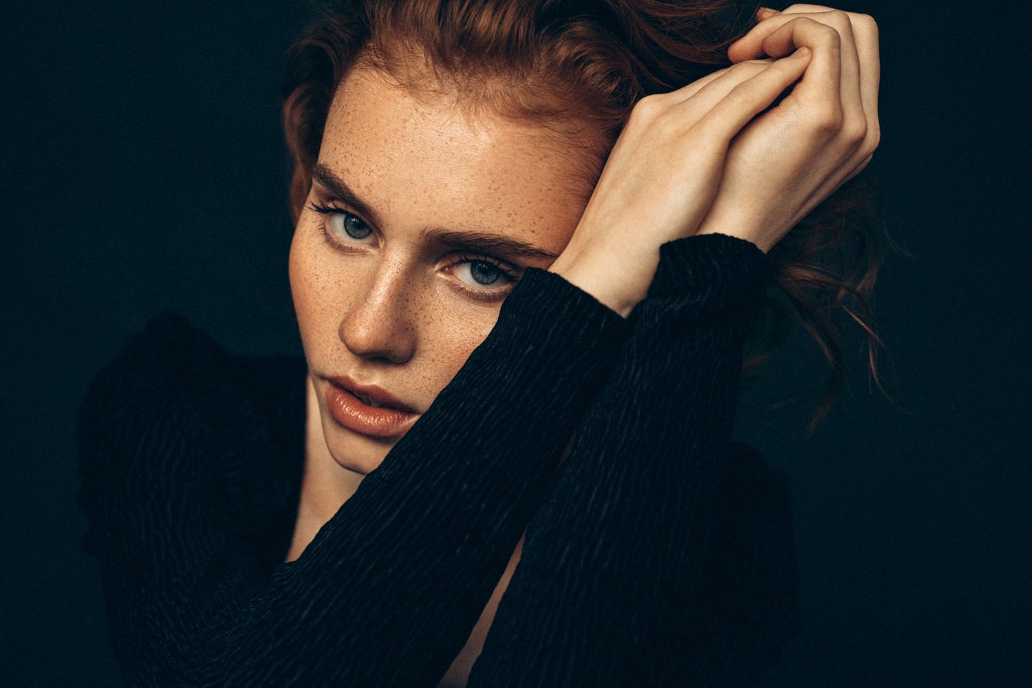 Close-up portrait of a woman with freckles.