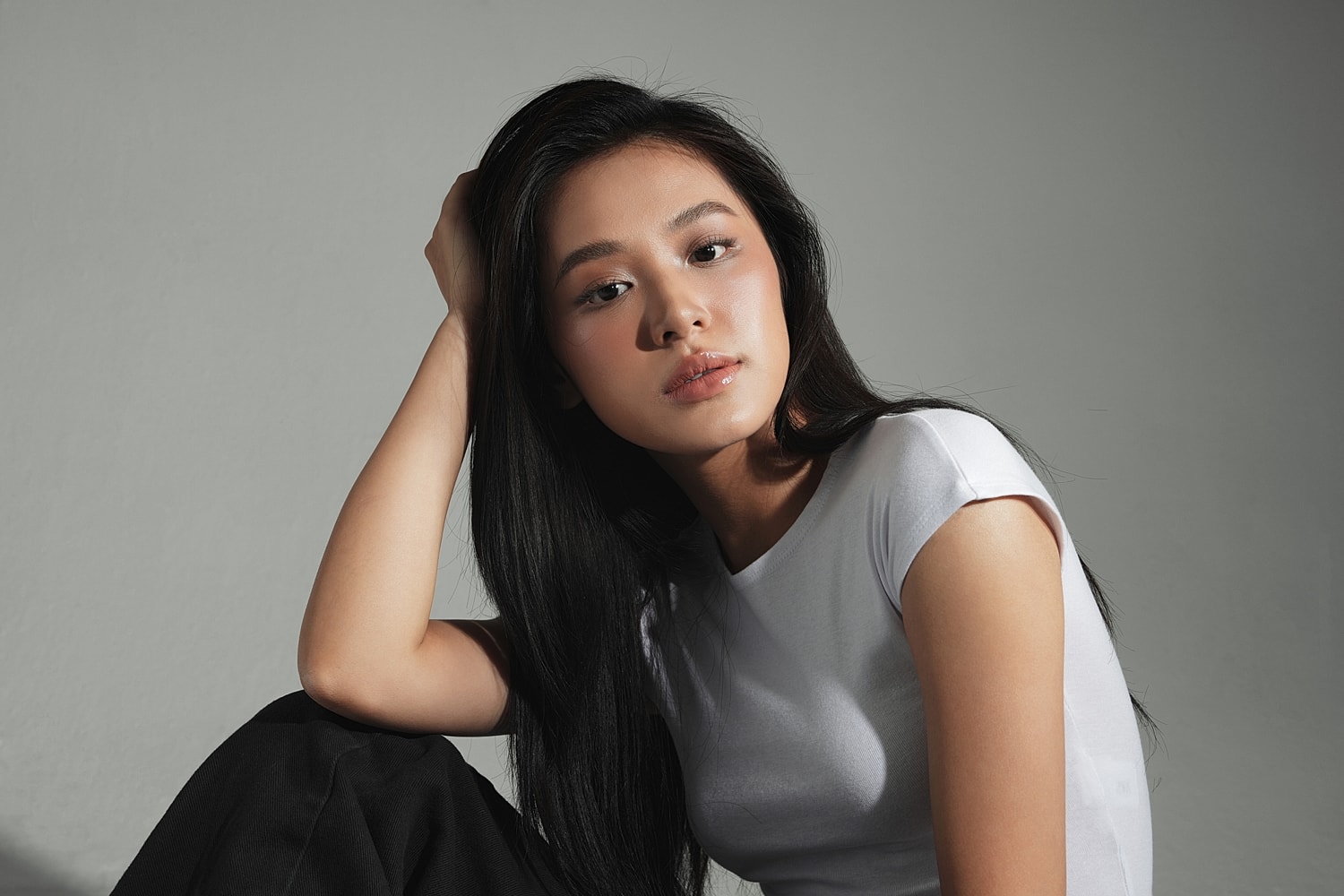 Woman with long hair in a white shirt.
