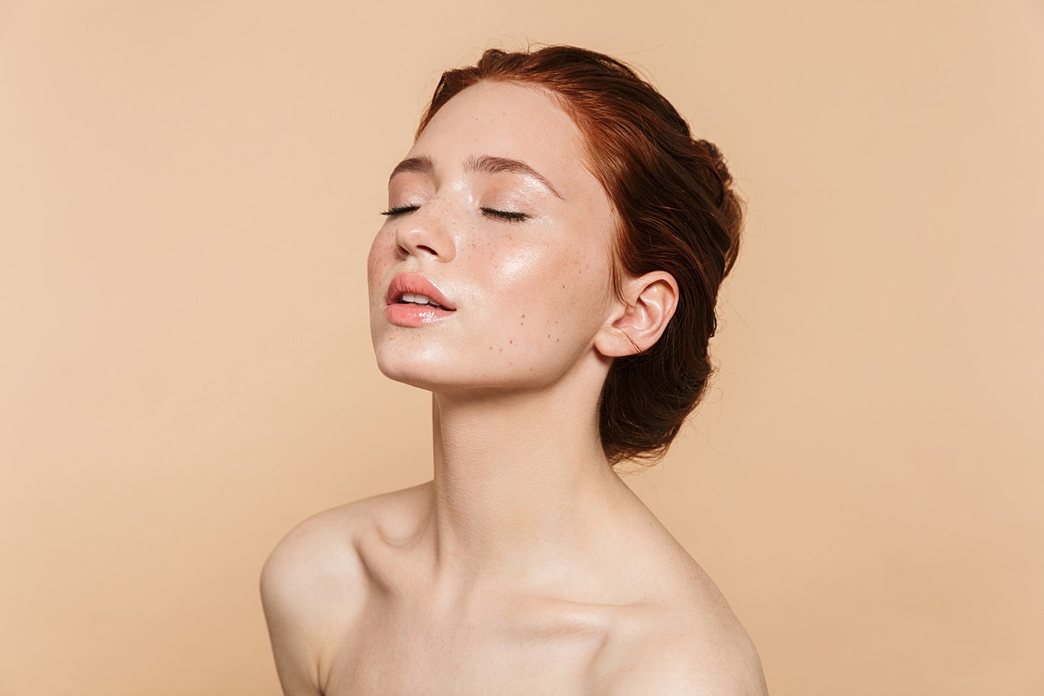 Close-up of a woman with glowing skin.